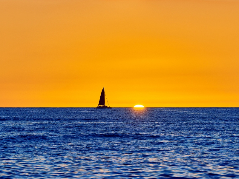 sailing the Pacific Ocean to Hawaii during sunset